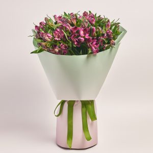 Elegant bouquet with vibrant pink flowers in a pastel wrap, flowers theme.